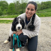 Mawoo customer sitting with her new Bernedoodle puppy