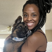 Mawoo customer smiling and holding german shepherd puppy