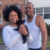 Couple holding newly received puppies