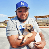 Customer hugging newly received puppy