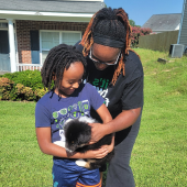 Mother and son holding a puppy they purchased